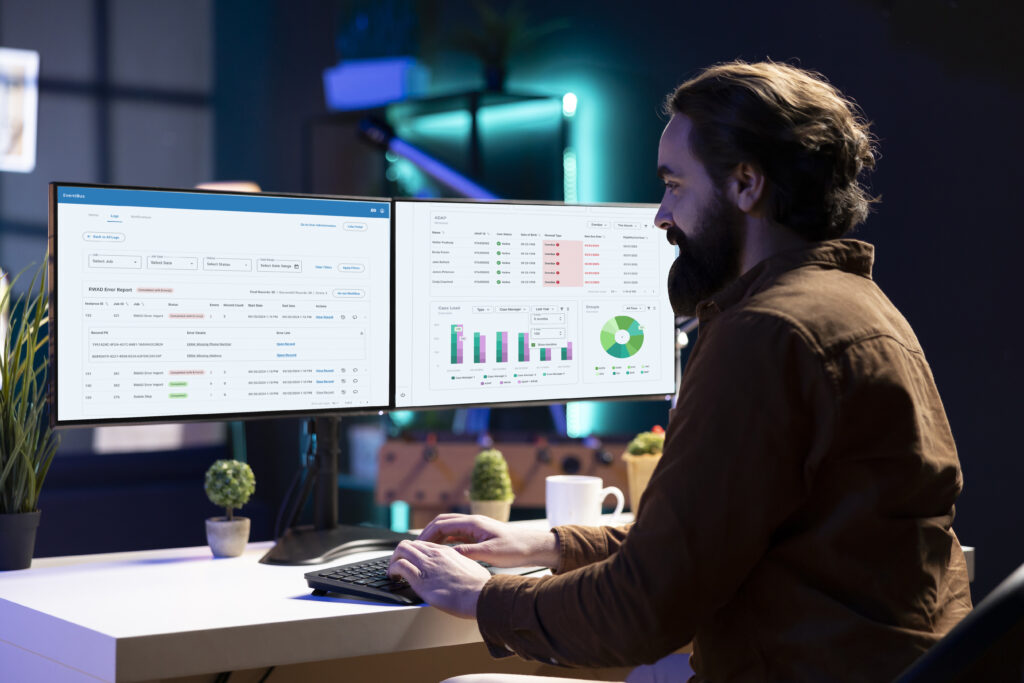 Happy developer in apartment writing lines of binary code on computer